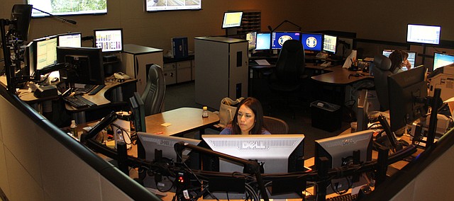 Amber Merritt, dispatcher and training officer, takes a call in the Shawnee Police Department's dispatch office Thursday. The city celebrated its 11 dispatchers this past week as part of National Public Safety Telecommunicators Week.