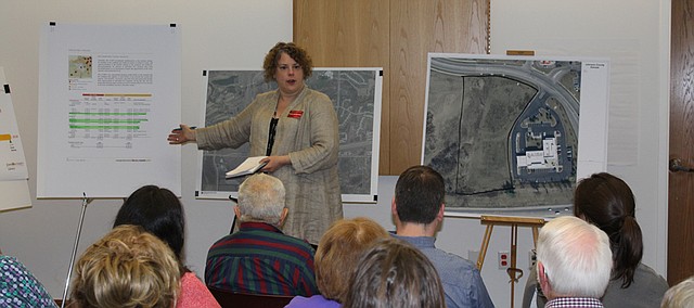 Tricia Suellentrop, deputy county librarian, discusses the history of the Johnson County Library's planning for the Monticello branch at Tuesday's meeting, referring to satellite maps of the site for the new branch and the library's 2015 Comprehensive Plan, which lists construction of the Monticello branch as the top priority.