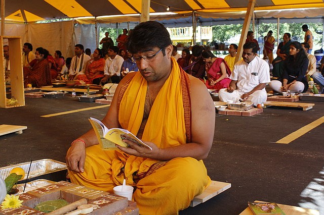 Ravi Aysola, of Overland Park, reads from a prayer book at the Hindu temple in Shawnee.