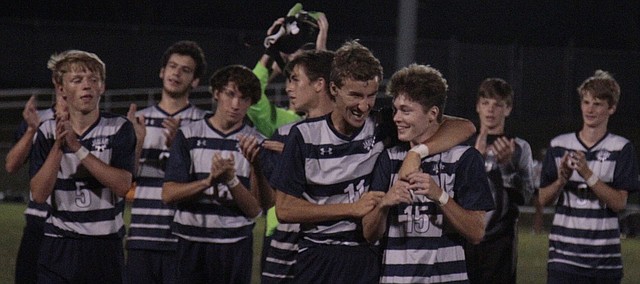 Mill Valley junior Jake Ashford puts his arm around teammate Brock Denney after the Jaguars' 3-1 win over Shawnee Mission Northwest on Thursday. Ashford scored twice to help push Mill Valley's record to 4-0.