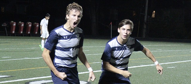 Mill Valley junior Jake Ashford (11) celebrates his go-ahead goal with senior Brent Stevenson (7) late in the second half of the Jaguars' 3-2 win over Bishop Miege on Thursday.