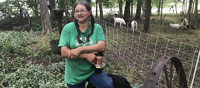 Mary Powell chats about her goats during a visit to Fred and Lisa Scheller's rural Tonganoxie residence. Her goats, known as the Barnyard Weed Warriors, mowed down the grove full of weeds. The goats also visited Cheryl Hanback and Richard Brown's rural Tonganoxie residence to eat the various weeds in their pasture. The animals eat various types of noxious weeds and other vegetation, including poison ivy.