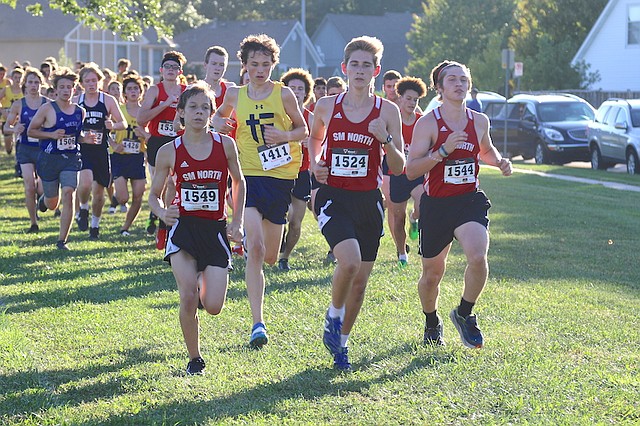 Members of the Shawnee Mission North High School cross country team run in a varsity quadrangular meet Wednesday night at Frontier Trail Middle School in Olathe.