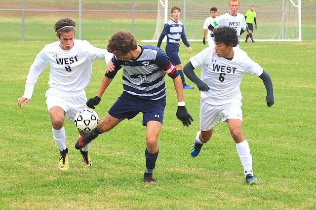 Mill Valley High School soccer senior Jake Ashford (No. 11) tries to control the ball against Shawnee Mission West High School in a Regional finals match Thursday at Mill Valley High School in Shawnee.