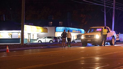 A traffic cone marks the spot where an injured man was found after being hit by truck in the eastbound lanes of 75th Street near Stearns Street shortly before 7 p.m. on Tuesday.