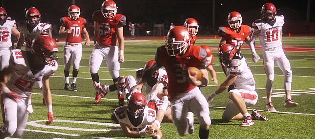 Tonganoxie High senior Tyler Bowden scampers toward the end zone Friday against Lansing. Bowden scored five touchdowns for Tonganoxie in a 49-10 playoff victory against the Lions. THS improved to 9-1 with the Class 4A regional playoff victory and now will face Bishop Miege, the team that ended Tonganoxie's season a year ago.
