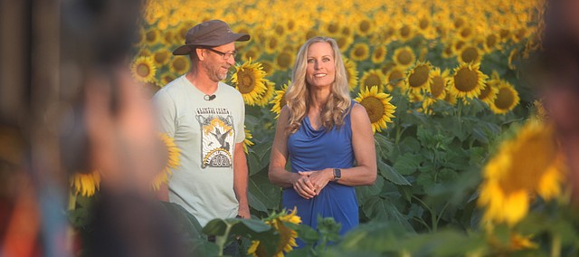 Ted Grinter stands with Becky Worley during an interview Thursday, Sept. 9, 2021, in one of the sunflower fields at Grinter Farms 4 miles south of Tonganoxie. Worley featured Grinter Farms during a Rise and Shine segment profiling Kansas on "Good Morning America." ABC's national morning show is highlighting all 50 states. Kansas marked state No. 30 in the series.