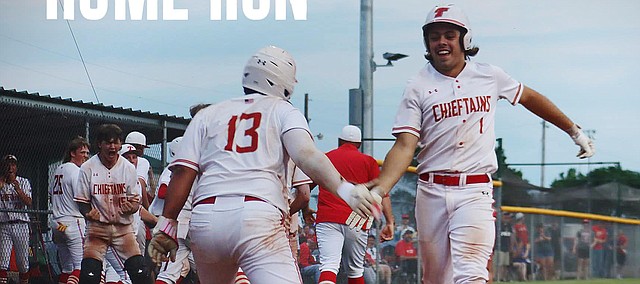 Tonganoxie High's Rocco Gehring (13) greets teammate Sam Kleidosty (1) at home plate after Kleidosty sent a pitch over the left-center field fence during a Class 4A regional championship game May 17, 2022, at the Leavenworth County Fairgrounds. it marked Kleidosty's first home run of his high school career.