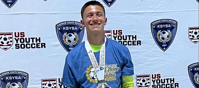 Jackson McWilliams holds the state trophy for the 16U U.S. Youth Soccer championships. McWilliams will join his Kansas City team in the 16-team national tournament later this month at Disney’s Wild World of Sports in Orlando, Fla.