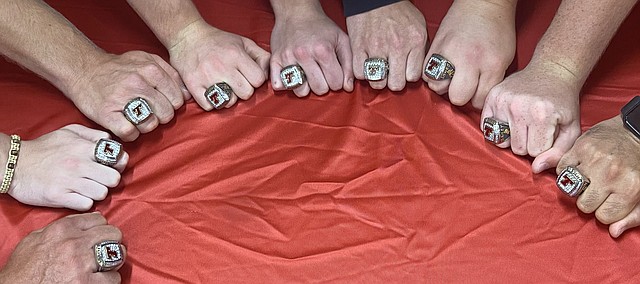 Some members of the 2022 Tonganoxie High boys wrestling state champion team receive their championship rings Thursday in their new wrestling room in the USD 464 Administrative Center (formerly west campus). 