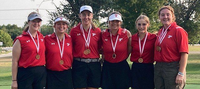 Tonganoxie High girls golf members celebrate team and individual titles Thursday at the Ottawa Invitational.