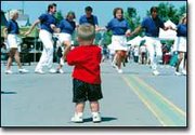 Taking in a performance by the Cowtown Cloggers, Jackson Willis,
19-months-old, stands motionless in the middle of Fourth Street.
Jackson, the son of Jack and Estee Willis, attended Tonganoxie Days
with his mother.