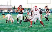 Paul Smith (22) gets in front of an Osawatomie Trojan to make a
tackle in Friday night's game at Laws Field. The Cardinals pulled
out the 26-16 win.