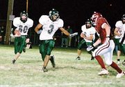 Ryan Brown leads the blocking for Shawn Roberts in the Wildcats
28-19 road loss to the Eudora Cardinals. The tough defeat left De
Soto 5-2 on the season but with hope remaining for post-season play
if it can win its two remaining regular-season games. The first of
those will be a Friday home game against arch-rival Mill Valley.