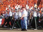 Band director Justin Love leads 76 De Soto High School band members
and flag corps onto the Cotton Bowl stadium field on Jan. 2.