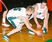 Brady Seaman and Pete Crall go to the floor for a loose ball in
Tuesday's De Soto High School Wildcats home win against Lansing.
The win was the team's second in a row.
