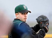 Matt Lowe stares down a Mill Valley batter early in De Soto High
School's double header against Mill Valley. Despite Lowe's strong
pitching performance, the Wildcats lost the game to their rivals
3-2. The team is in action again Friday at its new ball field, at
Kansas Highway 7 and 83rd Street.
