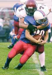 Eudora High School Senior Phil Lister brings down Wellsville's Kyle
Rush during Friday's game in Wellsville. The Cardinals opened the
season by claiming a 21-0 win over the Eagles.