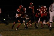 LHS junior quarterback Matt Warner slips through a hole in the line and breaks into the open field during the fourth quarter Tuesday night against De Soto.