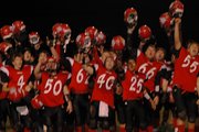 LHS football players raised their helmets and shouted "Thank You" to their fans who endured chilly weather Tuesday night to cheer for the Lions in their 10-7 bidistrict victory over De Soto.