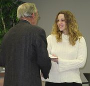 Lansing Mayor Kenneth Bernard recognized two area students for their volunteer service during Thursday's meeting of the Lansing City Council. Here Bernard congratulates Crystal Buck.