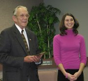 Lansing Mayor Kenneth Bernard recognized two area students for their volunteer service during Thursday's meeting of the Lansing City Council. Here, Bernard congratulates Tiffany Zimmerman.