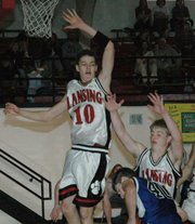 Lansing High freshman Stephen Didde soars to defend against a Gardner-Edgerton player's shot on Saturday.