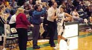 Amy Petty is greeted with high-fives by the Wildcat coaching staff
as she heads to the bench late in De Soto's victory over Prairie
View. The senior guard scored 37 points in the game.