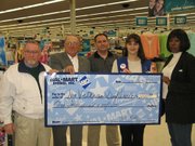 Members of the 2005 Leavenworth County Veterans Day Parade received a donation of $1,000 from Wal-Mart Tuesday. From left are John Carroll, committee member; Joe Lauber, 2005 parade chairman; Jerry Hansen, committee member; Jodi Morris-Neville, Wal-Mart assistant manager; and Diane Smith, secretary of the parade committee.