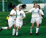 Andrea Young, Julie Bray and Nicole Radcliffe celebrate the first
goal of the match against Harmon. Seven other goals followed Bray's
initial score
