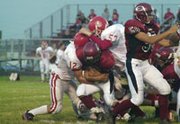 Luke Abel crashes through the line Friday against Osawatomie. The
Trojans relied on big plays and lucky bounces and took a 22-18 lead
in the fourth quarter. Eudora answered back and went 70 yards in
seven plays to score and remain undefeated.