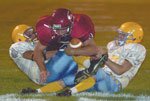 James Mills (bottom) blasts through them Friday night. Mills piled
up four more scores in the 61-6 blowout.
