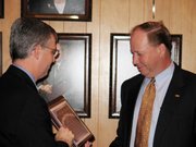 Lew Ebert, left, president of the Kansas Chamber of Commerce, presents Lansing State Rep. Kenny Wilk with a plaque proclaiming Wilk a "2005 Pro-Jobs Legislator." State chamber officials called on Wilk on Tuesday at the offices of the Leavenworth-Lansing Chamber of Commerce.