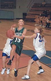 Kayla Bader goes up for a layup in Monday's 49-26 season-opening
win over Wellsville. Bader was one of three Cats to score in double
figures, finishing with 10 points.