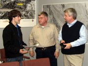 Matthew Gledhill, left, speaks with Lansing City Council members Billy Blackwell, center, and Harland Russell after the Dec. 15 council meeting. The council in January will take up Gledhill's proposal to ban smoking in all public places, including workplaces, bars and restaurants.