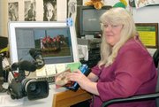 Sue Ryan sits at her desk in her classroom at Basehor-Linwood High School. Her desk has served as an editing bay for the last five years while she has produced football highlight videos for the Lansing High football team.