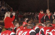 Sue Ryan, at left with camera, films while LHS football coach Bill Pekarek addresses his team after the Lions lost in the regional championship game to Holton.