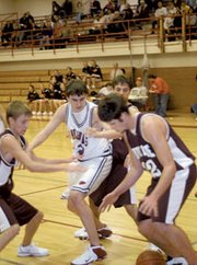 Guy Montgomery and a trio of Silver Lake players battle for a loose
ball Monday as Eudora fell in the opening round of the Tonganoxie
tournament, 50-43.