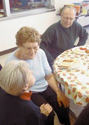 Lana McPherson wishes Mary Bichelmeyer well during a reception for
the longtime manager of the De Soto Senior Center last Thursday at
the center. Bichelmeyer is leaving the center with her Feb. 17
marriage to Richard Dikeman (right).
