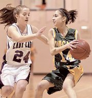 Amber Jeannin (14) of Basehor-Linwood looks to get past Rachel Pyle
(24) of Eudora Monday during first-round action of sub-state.
Eudora won the game 58-40 and earned the right to play Sumner
Academy Thursday at 7:30 p.m.