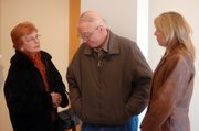 Family members of Toby Young gather in the foyer of the Leavenworth County Justice Center after Young's brief court appearance Friday, March 3. From left is Young's mother and father, Peggy and Jim Phalen, and Young's sister, Julie. Young is charged with helping convicted murderer John M. Manard escape Feb. 12 from the Lansing Correctional Facility.