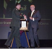 Lt. Gen. David Petraeus, Commander of the Combined Arms Center and Fort Leavenworth, congratulates retired Army Gen. Gordon Sullivan upon his induction as the 91st member of the Fort Leavenworth Hall of Fame during a ceremony on post May 2. Sullivan, who graduated from the U.S. Army Command and General Staff College in 1969 and returned as the its deputy commandant from March 1987 to June 1988, retired in 1995 after serving as the Army's Chief of Staff.