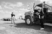 Leavenworth County counselor Keyta Kelly photographs a truck at the county shop as her legal assistant, Tammy Saldivar, takes notes. The county is selling surplus items through an online auction site. Items currently for sale can be seen online at www.leavenworthcounty.org/ surplus/surplus.cgi.