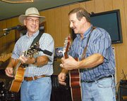 Garry Bichelmeyer of Tonganoxie and Larry Inman of De Soto share a
laugh during a recent performance in Eudora. Bichelmeyer recently
won a national songwriting contest in Nebraska after penning a song
in 24 hours on the subject "Mud in the Camper."