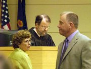 Toby Young, left, glances at her family after receiving a sentence of 21 months from Leavenworth County District Judge Frederick Stewart on July 12. By her side stands her longtime friend and attorney Jim Yoakum.