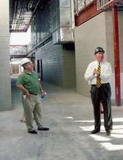 USD 232 board member Bill Waye listens Monday as Hollis and Miller
architect Kirk Horner explains details of Mill Creek Middle School
being built in Lenexa.