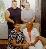 Linda King and Sharon Busey sit in front of Don Dolina and his
wife, Brenda, in the Dolina's home. Before arriving in Kansas on
Aug. 3, King and Busey hadn't seen Dolina for 28 years.