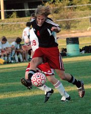 Andy Dick, Lansing High senior, unleashes a shot on goal Tuesday during Lansing's 3-0 victory at Tonganoxie. LHS outshot THS 42-8 in the game.
