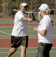 Hana Lindbloom reaches out to celebrate a point with Rebekah Gulley
during Saturday's Class 4A state tennis championship in Emporia.
The Wildcat doubles team finished second.