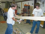 Martin Oehmler, 15, Olathe, and Nate Duerksen, 16, De Soto, put the
finishing touches on this year's robot, "Wes." The robot's
objective is to hang laundry. The team is taking their robot to
Wichita this week for the state competition for Boosting
Engineering through Science and Technology.